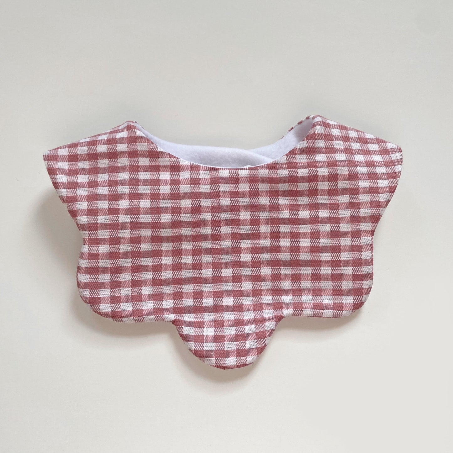 Dusky pink gingham scallop bib
