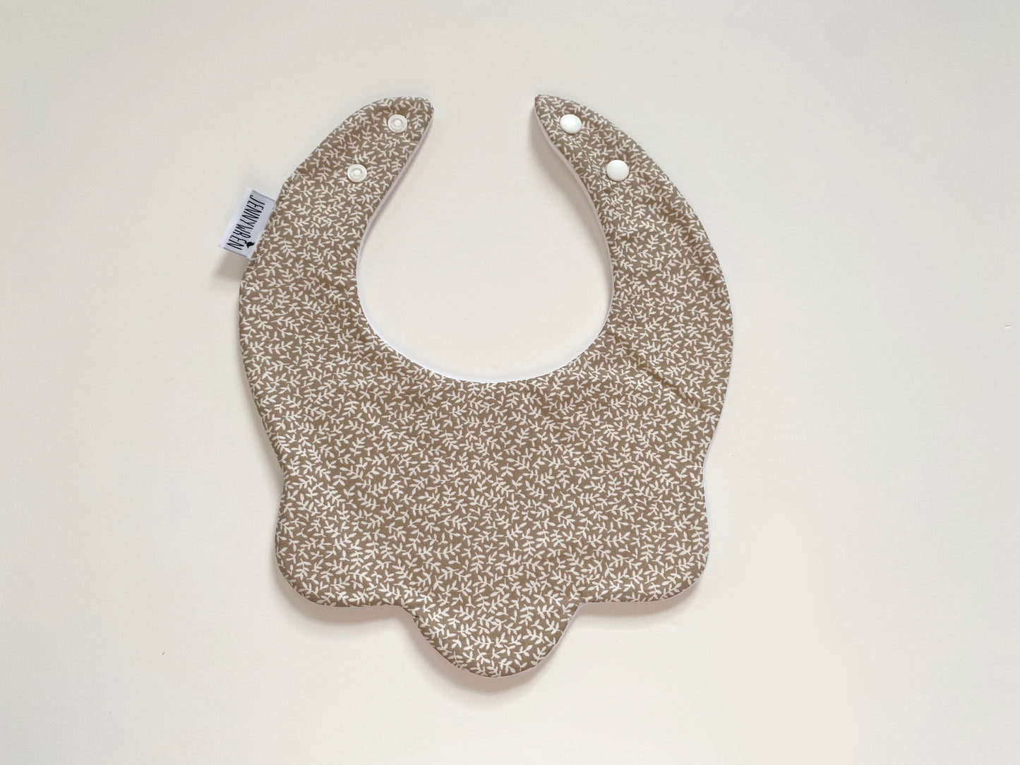 Beige floral scallop bib