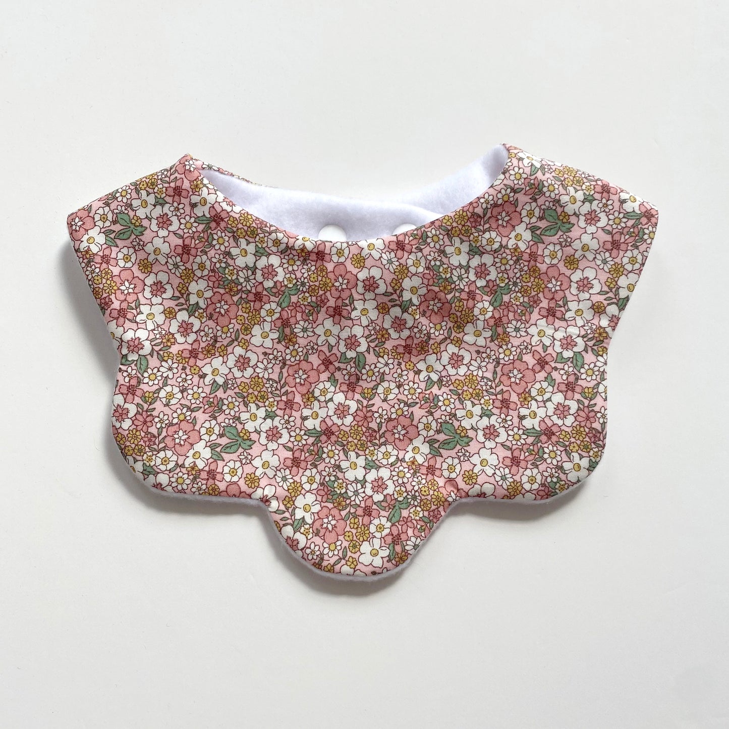 Pastel pink and yellow floral scallop bib