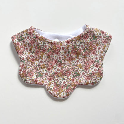 Pastel pink and yellow floral scallop bib