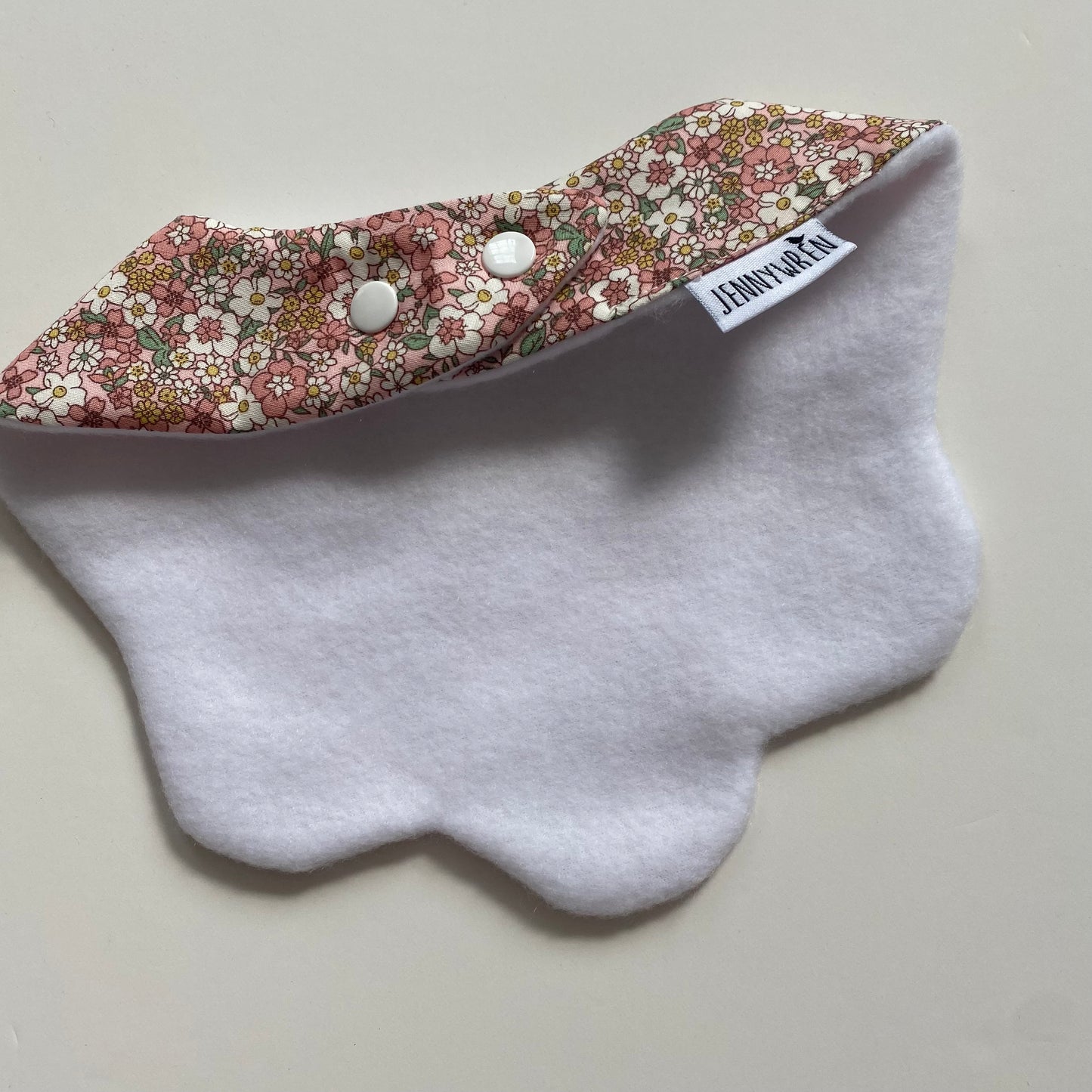Pastel pink and yellow floral scallop bib