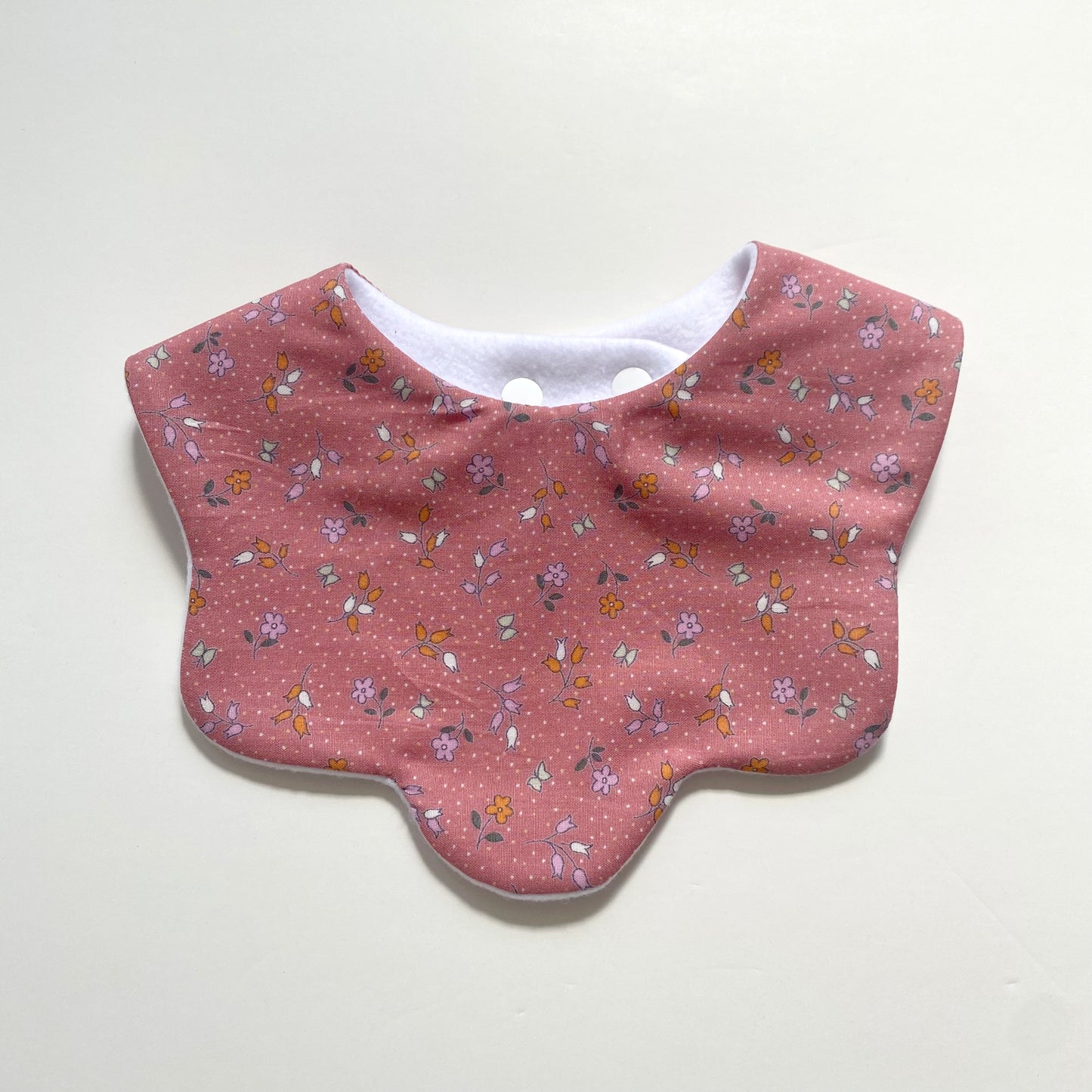 Pink ditsy scallop bib