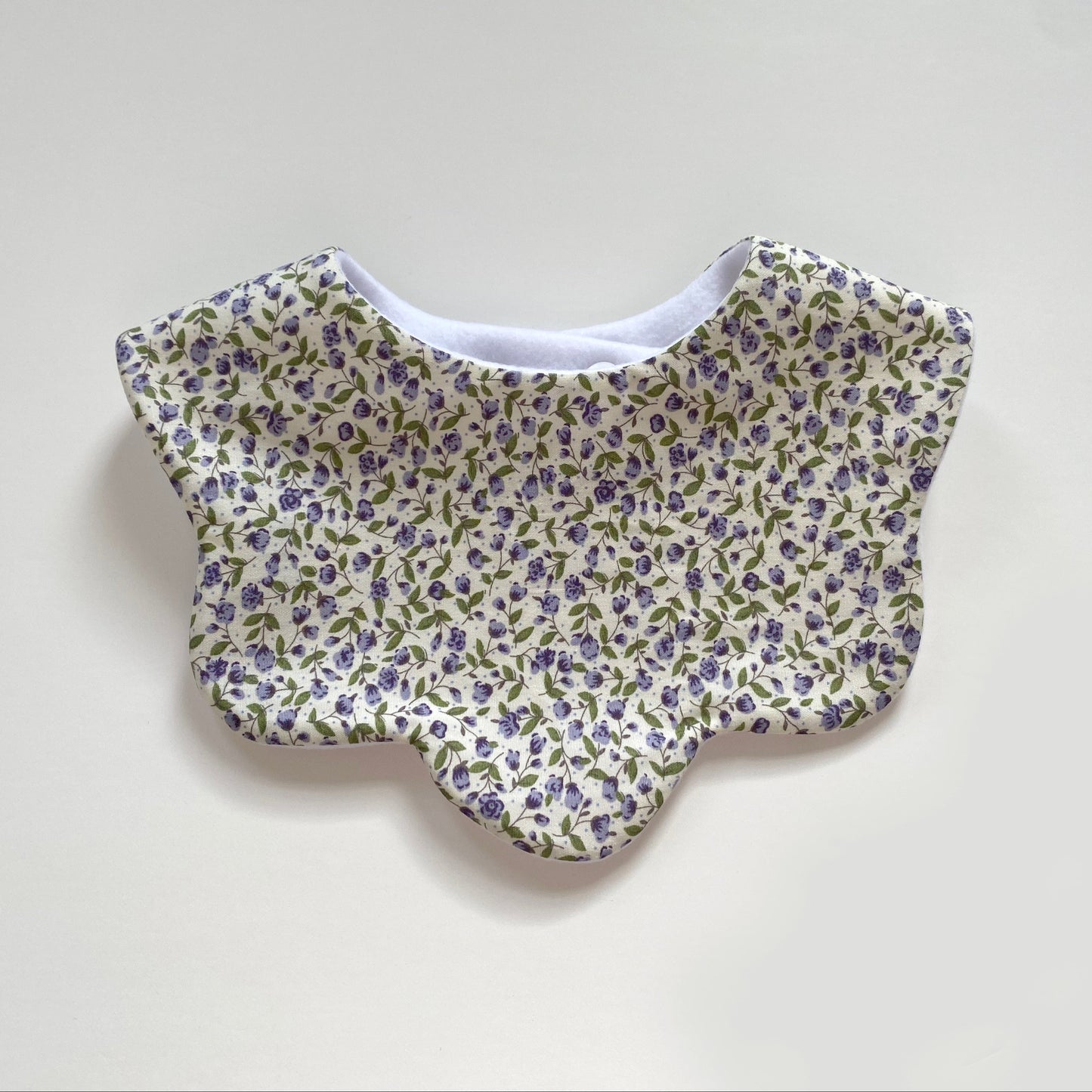 Cream with purple flowers scallop bib