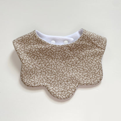 Beige floral scallop bib